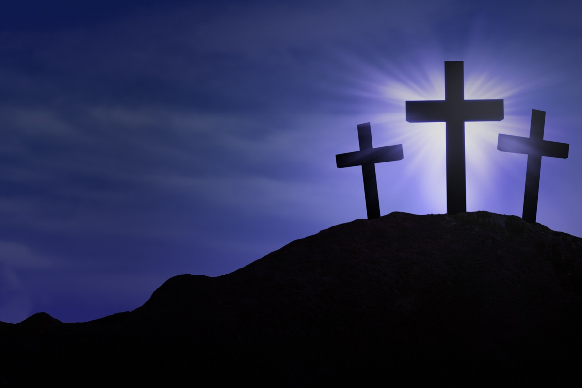 Silhouette of three crosses on blue background